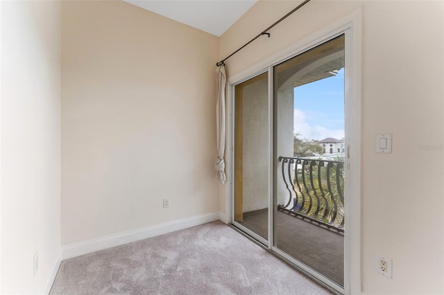 unfurnished room featuring light colored carpet and baseboards