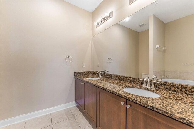 bathroom with visible vents, a sink, baseboards, and tile patterned floors