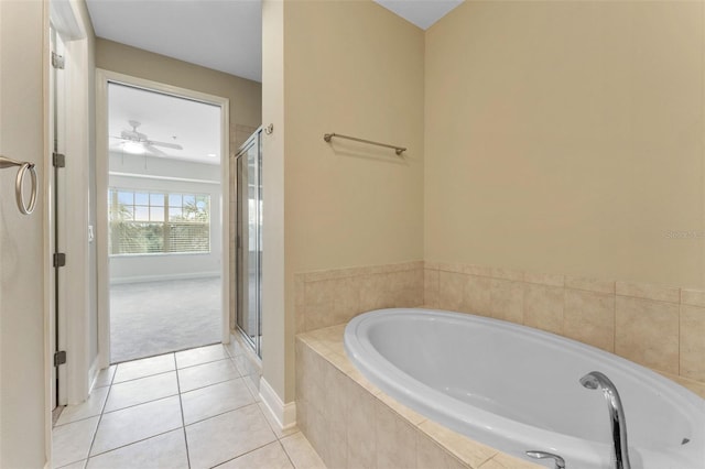 full bathroom with a garden tub, a ceiling fan, a shower stall, baseboards, and tile patterned floors