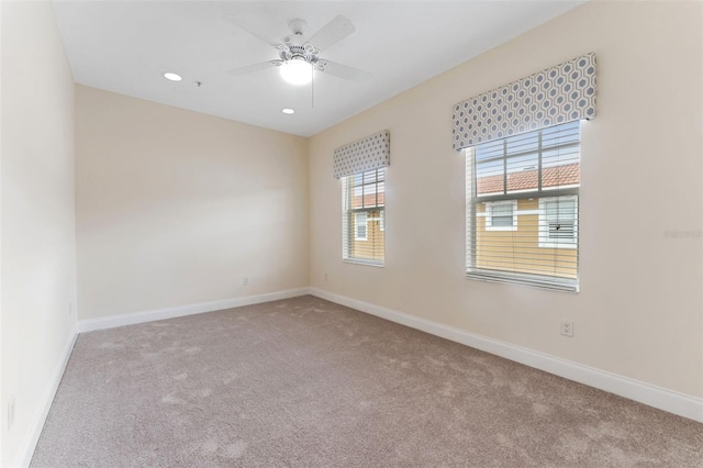 unfurnished room featuring ceiling fan, baseboards, and light colored carpet