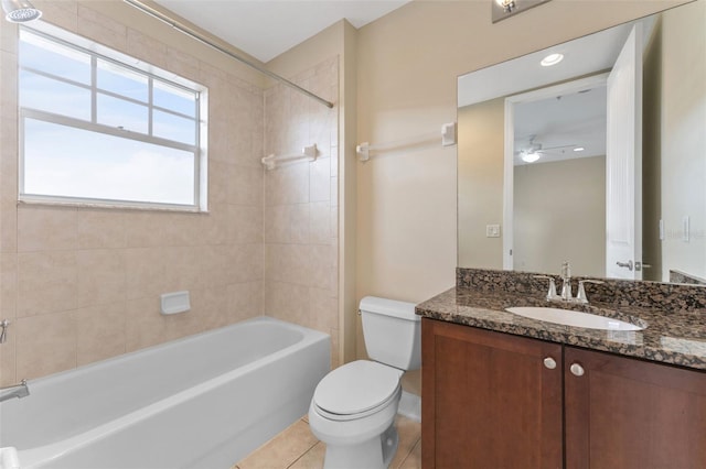 full bath featuring tile patterned flooring, toilet, vanity, a ceiling fan, and shower / bathing tub combination