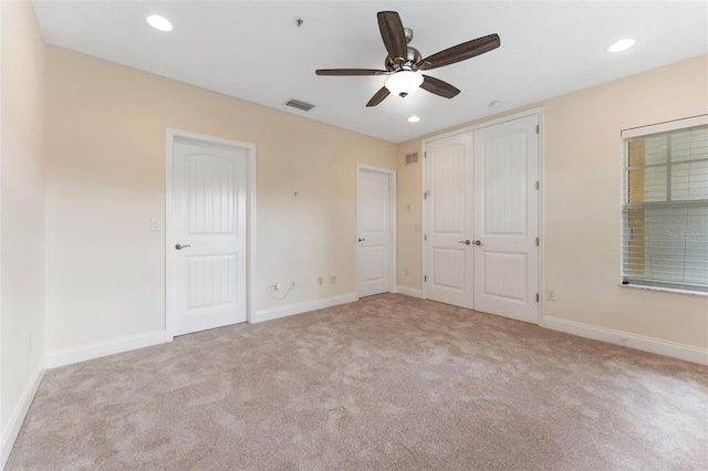 unfurnished bedroom with recessed lighting, light colored carpet, visible vents, ceiling fan, and baseboards