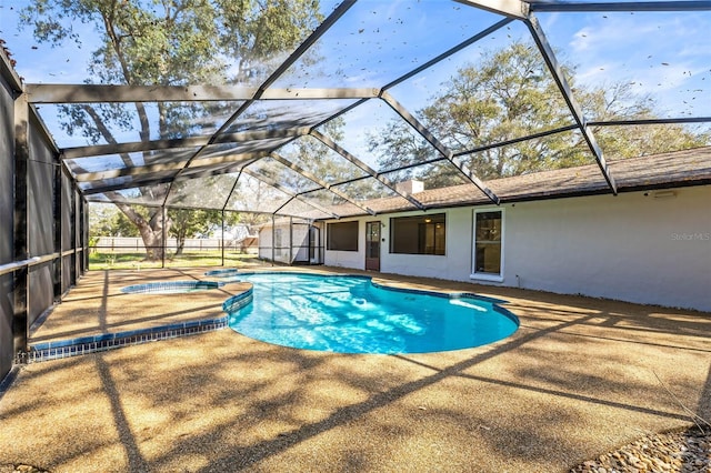 view of pool featuring a patio, a lanai, and a pool with connected hot tub