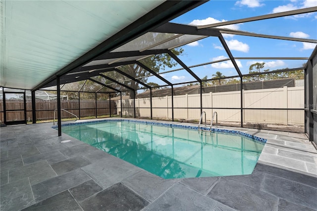 view of pool with a patio area, a fenced backyard, a fenced in pool, and a lanai