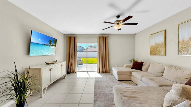 living area featuring a ceiling fan and light tile patterned floors