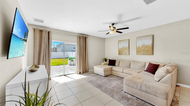 living room featuring visible vents, ceiling fan, baseboards, and light tile patterned floors