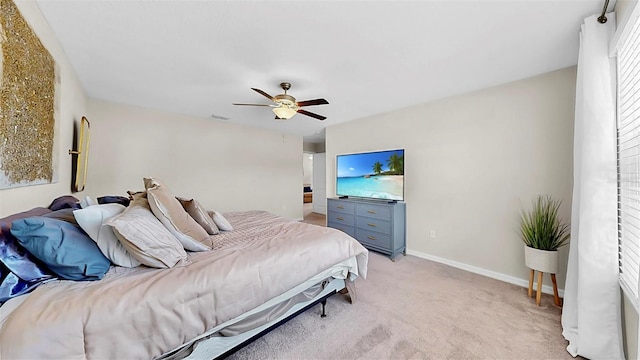 bedroom featuring light carpet, ceiling fan, visible vents, and baseboards