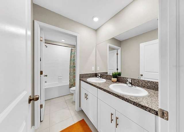 full bathroom featuring shower / bath combination with curtain, double vanity, a sink, and tile patterned floors