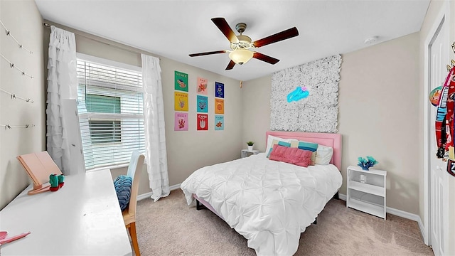 bedroom with light colored carpet, ceiling fan, and baseboards