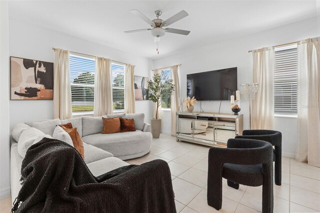 5994 Shiner St, Land O Lakes, FL 34638 - living area featuring light tile patterned floors, a ceiling fan, and baseboards