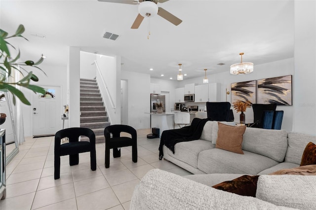 5994 Shiner St, Land O Lakes, FL 34638 - living room featuring light tile patterned floors, recessed lighting, visible vents, stairway, and ceiling fan with notable chandelier