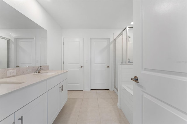 5994 Shiner St, Land O Lakes, FL 34638 - bathroom with double vanity, a stall shower, a sink, and tile patterned floors