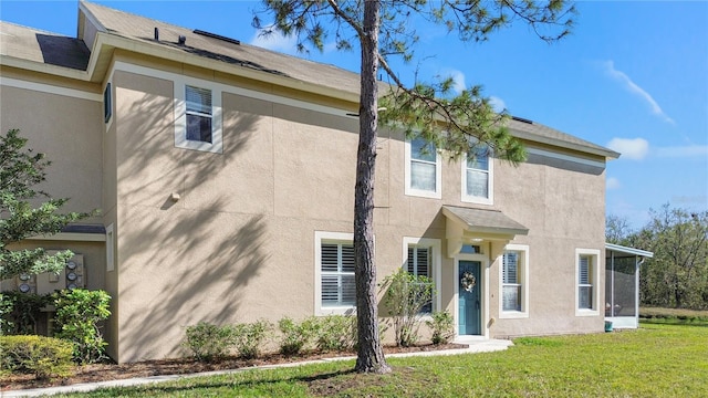 view of front of home featuring a front lawn and stucco siding