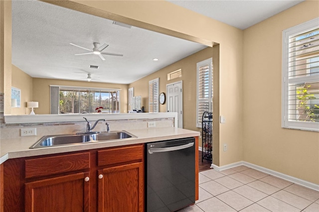 2824 Conch Hollow Dr, Brandon, FL 33511 - kitchen with black dishwasher, light tile patterned floors, light countertops, a sink, and a textured ceiling