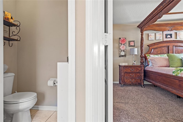 2824 Conch Hollow Dr, Brandon, FL 33511 - bedroom with light tile patterned floors, a textured ceiling, light colored carpet, and baseboards