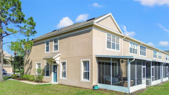 2824 Conch Hollow Dr, Brandon, FL 33511 - rear view of house with a sunroom, a yard, and stucco siding