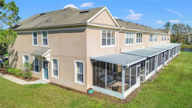2824 Conch Hollow Dr, Brandon, FL 33511 - rear view of property featuring a sunroom, a lawn, and stucco siding