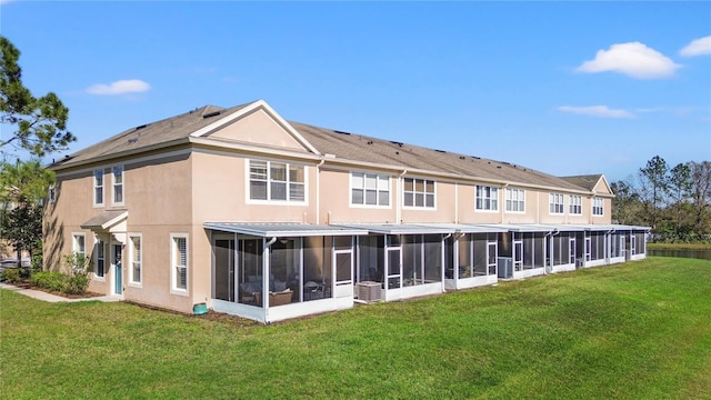 2824 Conch Hollow Dr, Brandon, FL 33511 - back of house featuring a lawn, a sunroom, and stucco siding