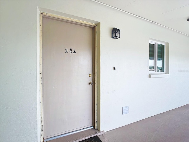 doorway to property with stucco siding