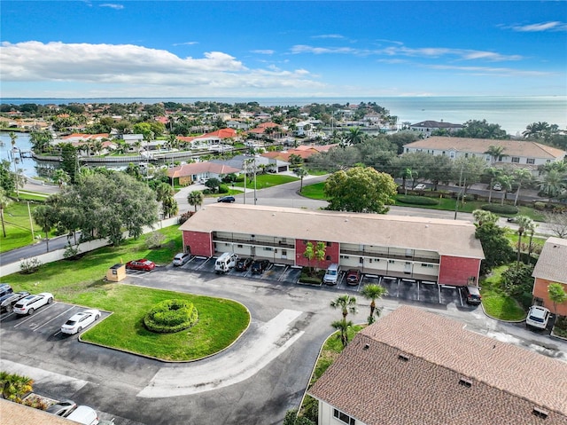 drone / aerial view with a water view and a residential view