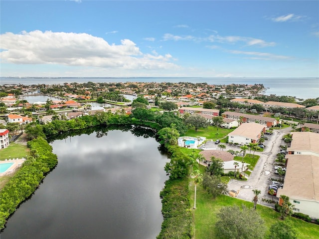 drone / aerial view featuring a water view and a residential view