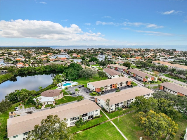 drone / aerial view with a water view and a residential view