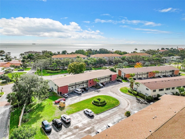 drone / aerial view featuring a residential view and a water view