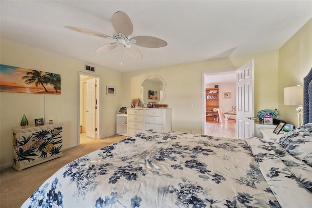 bedroom with light carpet, visible vents, and a ceiling fan