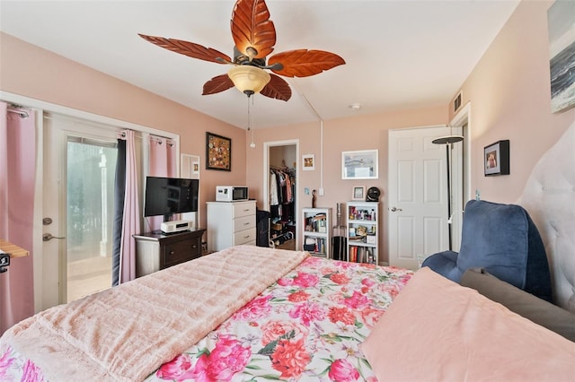 bedroom featuring a ceiling fan, a walk in closet, a closet, and visible vents