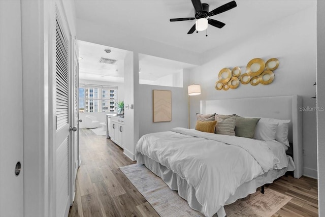 bedroom with visible vents, light wood-style flooring, and baseboards