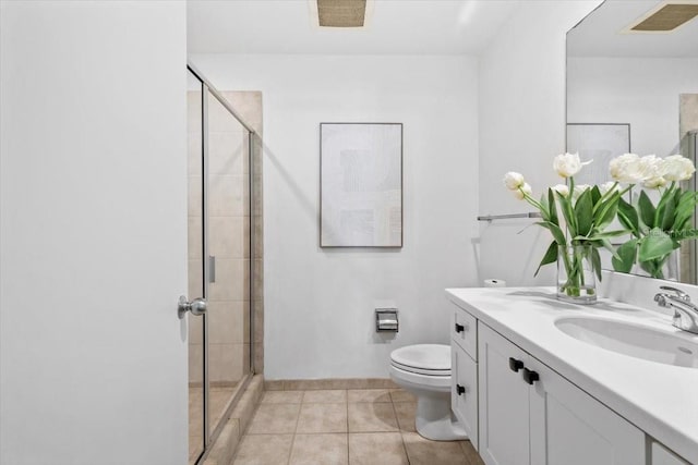 bathroom featuring toilet, tile patterned flooring, vanity, and a shower stall