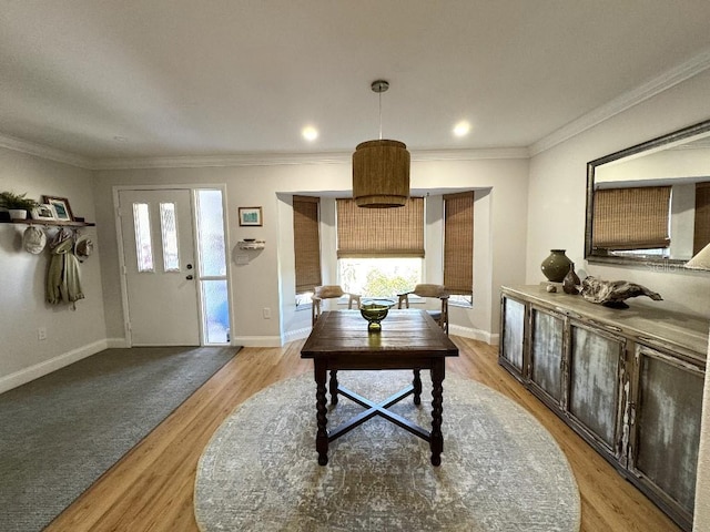 interior space featuring a healthy amount of sunlight, light wood-style flooring, baseboards, and ornamental molding