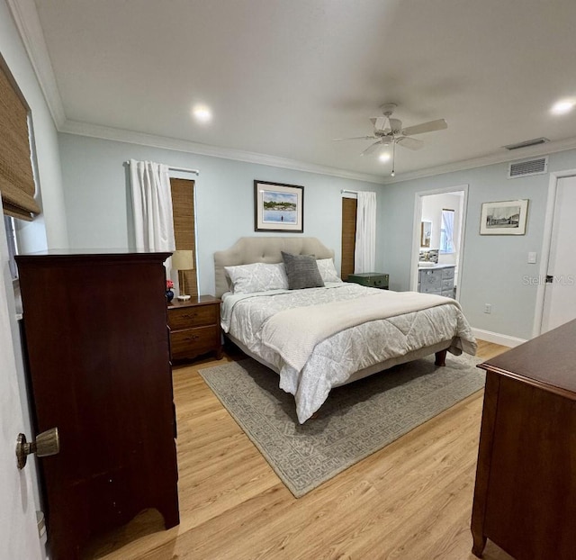 bedroom featuring visible vents, ornamental molding, and light wood-style flooring