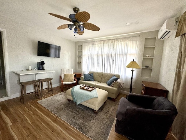 living room featuring baseboards, dark wood-type flooring, a wall mounted air conditioner, and built in features