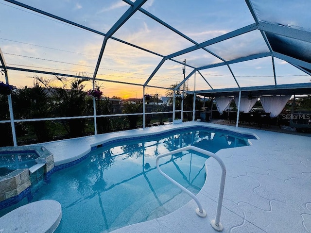 view of swimming pool with glass enclosure, a pool with connected hot tub, and a patio