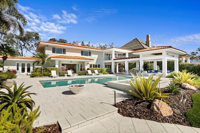 611 Brightwaters Blvd NE, Saint Petersburg, FL 33704 - back of house with a ceiling fan, an outdoor pool, a patio, and a tiled roof
