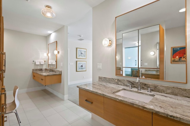 611 Brightwaters Blvd NE, Saint Petersburg, FL 33704 - bathroom featuring baseboards, two vanities, a sink, and tile patterned floors