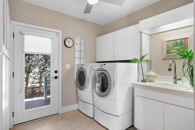 611 Brightwaters Blvd NE, Saint Petersburg, FL 33704 - washroom featuring light wood finished floors, cabinet space, ceiling fan, a sink, and separate washer and dryer