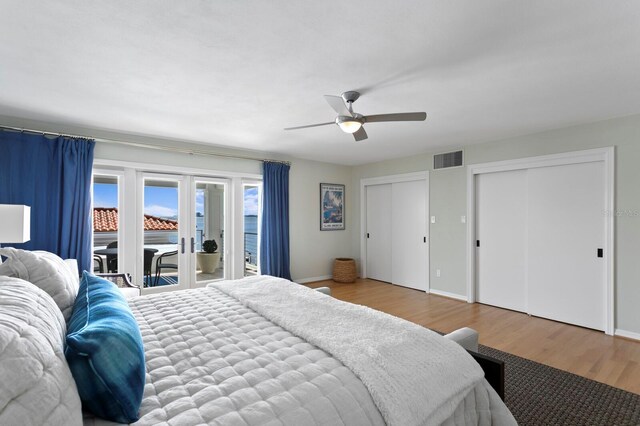 611 Brightwaters Blvd NE, Saint Petersburg, FL 33704 - bedroom featuring wood finished floors, visible vents, baseboards, multiple closets, and access to exterior