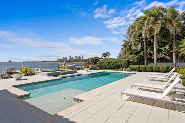 611 Brightwaters Blvd NE, Saint Petersburg, FL 33704 - view of swimming pool featuring a patio area, a water view, a pool with connected hot tub, and a city view