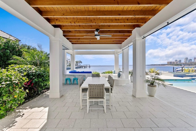 611 Brightwaters Blvd NE, Saint Petersburg, FL 33704 - view of patio / terrace with a water view, an outdoor pool, a ceiling fan, and outdoor dining space