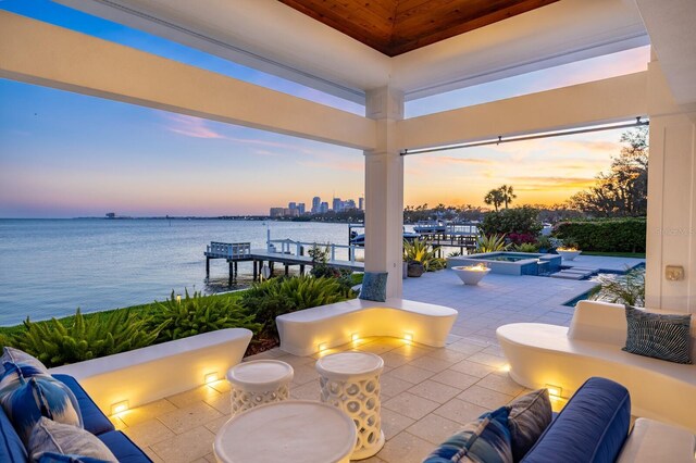 611 Brightwaters Blvd NE, Saint Petersburg, FL 33704 - patio terrace at dusk with a water view, a pool with connected hot tub, and outdoor lounge area