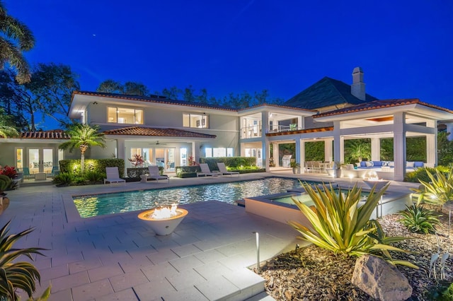 611 Brightwaters Blvd NE, Saint Petersburg, FL 33704 - pool at twilight featuring ceiling fan, french doors, a patio area, and an outdoor pool
