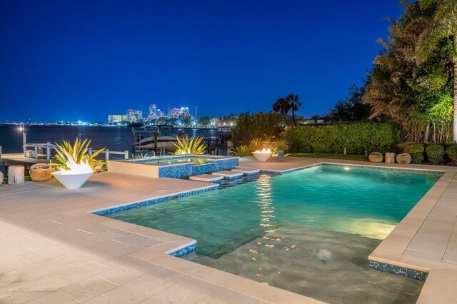 611 Brightwaters Blvd NE, Saint Petersburg, FL 33704 - pool at night with an outdoor pool, a patio, and an in ground hot tub