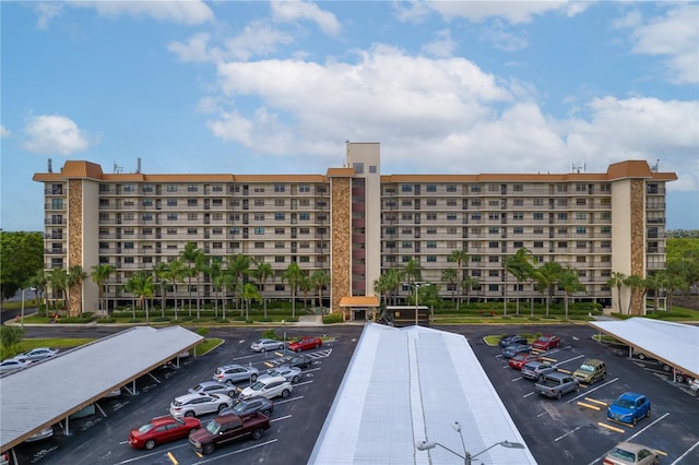 view of building exterior with uncovered parking