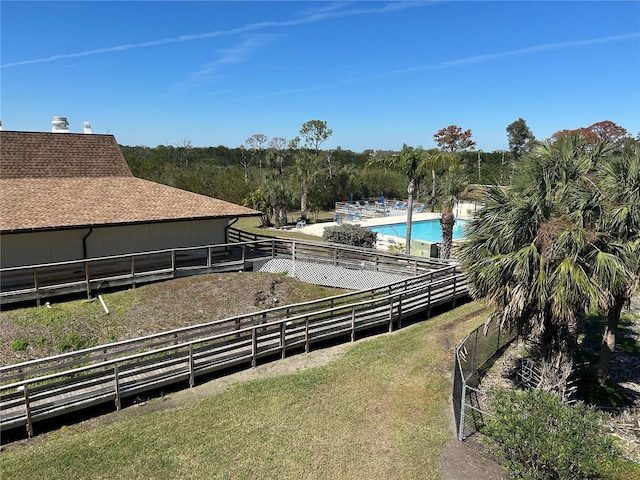 view of yard with fence and a community pool