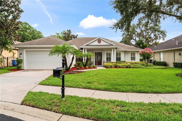 view of front of home with a garage, driveway, a front lawn, and stucco siding