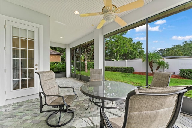 sunroom featuring ceiling fan