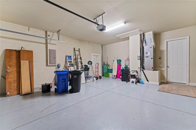 garage featuring heating unit, electric panel, and a garage door opener