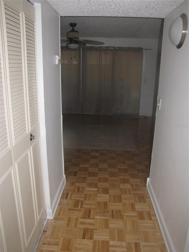 hallway featuring baseboards